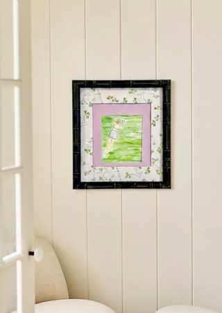 Framed picture on a wall with a chair and door in the foreground for anthro