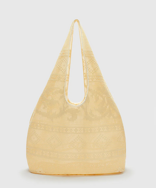 Beige woven handbag on a light gray background