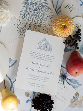 Wedding invitation card with decorative elements on a patterned surface