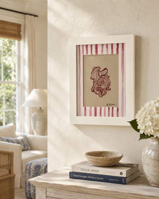 Framed artwork on a wall with a living room setting