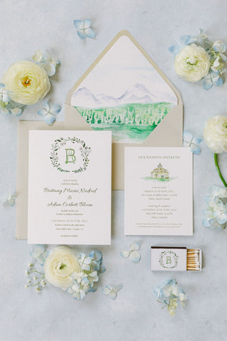 Wedding invitation set with floral decorations on a light gray background