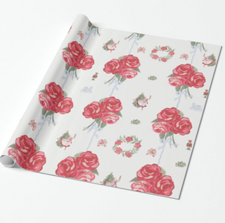 Roll of floral wrapping paper with pink roses on a white background