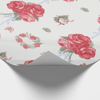 Floral patterned paper with pink roses and green leaves on a white background