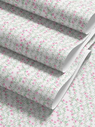 Floral patterned paper with pink flowers and green leaves on a white background